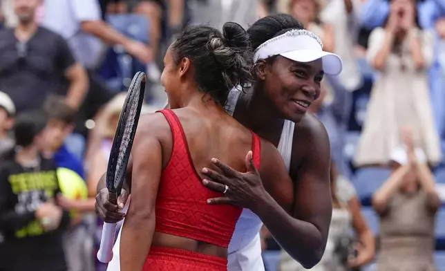 Venus Williams, of the United States, right, and Leylah Fernandez, of Canada, hug after defeating Lyudmyla Kichenok, of the Czech Republic and Ellen Perez, of Australia, in a first round women's doubles match during the U.S. Open tennis championships, Thursday, Aug. 28, 2025, in New York. (AP Photo/Yuki Iwamura)