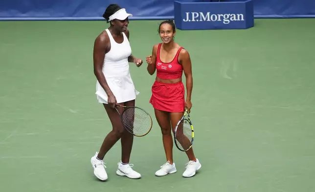 Venus Williams, of the United States, left, and Leylah Fernandez, of Canada, talk on the court during a first round women's doubles match against Lyudmyla Kichenok, of the Czech Republic and Ellen Perez, of Australia, during the U.S. Open tennis championships, Thursday, Aug. 28, 2025, in New York. (AP Photo/Yuki Iwamura)