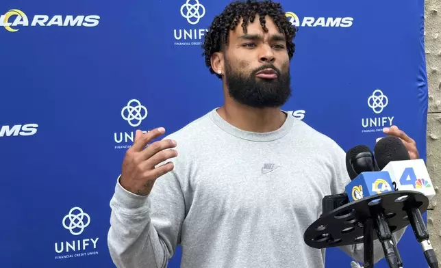 Los Angeles Rams running back Kyren Williams gestures while speaking to reporters before the start of NFL football training camp at Loyola Marymount University in Los Angeles, Tuesday, July 22, 2025. (AP Photo/Greg Beacham)