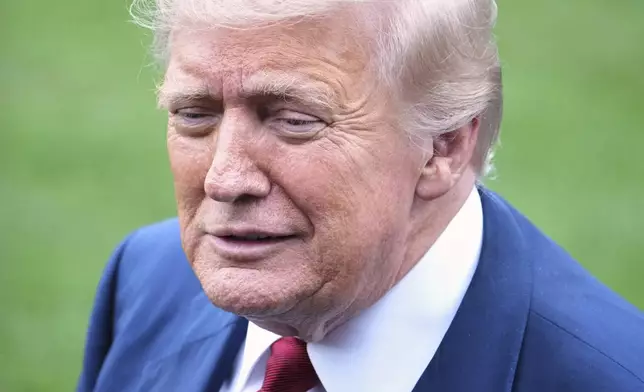 President Donald Trump speaks with reporters before walking across the South Lawn of the White House to board Marine One en route to Joint Base Andrews, Md., Friday, Aug. 1, 2025, in Washington. (AP Photo/Jacquelyn Martin)
