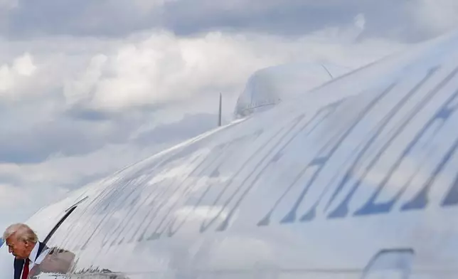 President Donald Trump disembarks Air Force One at Lehigh Valley International Airport, Friday, Aug. 1, 2025, in Allentown, Pa. (AP Photo/Julia Demaree Nikhinson)