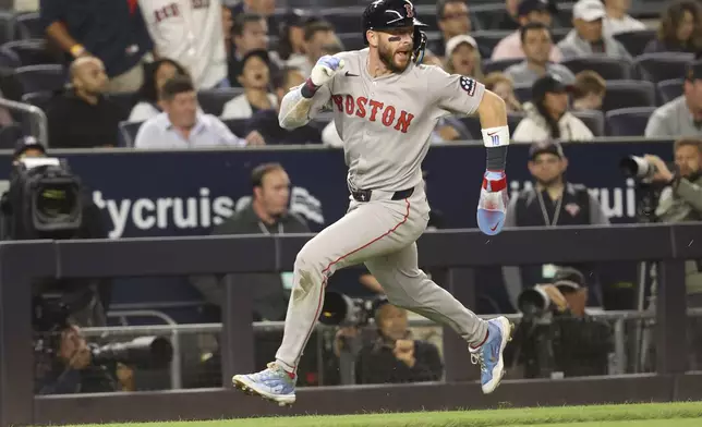 Boston Red Sox's Trevor Story runs to score on a double hit by Nathaniel Lowe during the seventh inning of a baseball game against the New York Yankees, Thursday, Aug. 21, 2025, in New York. (AP Photo/Pamela Smith)
