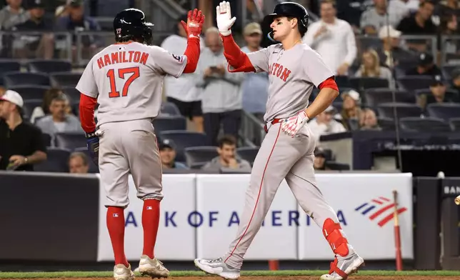 Boston Red Sox's David Hamilton, left, and Roman Anthony, right, react after Anthony hit a two-run home run during the ninth inning of a baseball game against the New York Yankees, Thursday, Aug. 21, 2025, in New York. (AP Photo/Pamela Smith)