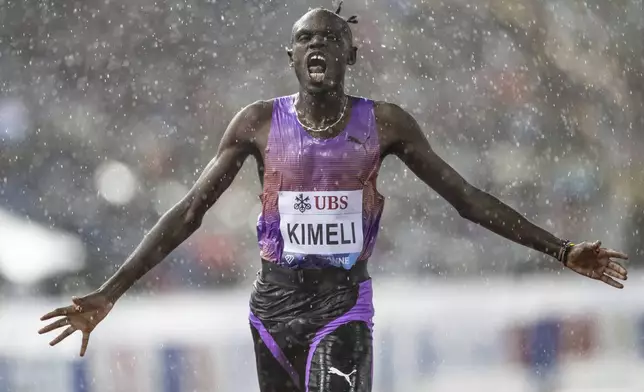Isaac Kimeli,of Belgium, reacts as he crosses the finish line to win the men's 5,000-meter event at the Wanda Diamond League 'Athletissima Lausanne' athletics meeting in Lausanne, Switzerland, Wednesday, Aug. 20, 2025. (Laurent Gillieron/Keystone via AP)