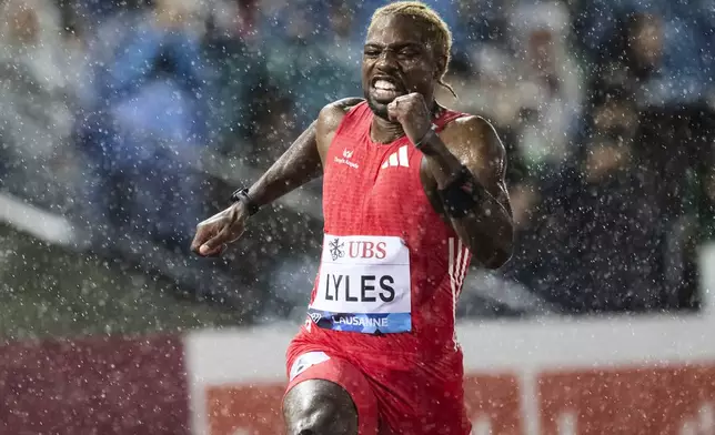 Noah Lyles, of United States, finishes second in the men's 100-meter race at the Wanda Diamond League 'Athletissima Lausanne' athletics meeting in Lausanne, Switzerland, Wednesday, Aug. 20, 2025. (Laurent Gillieron/Keystone via AP)
