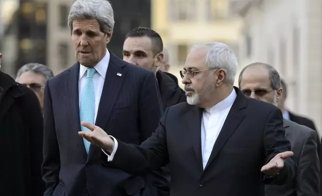 FILE - US Secretary of State John Kerry, left, listens to Iranian Foreign Minister Mohammad Javad Zarif, as they walk in the city of Geneva, Switzerland, Jan. 14, 2015, during a bilateral meeting ahead of the next round of nuclear discussions. (AP Photo/Keystone, Martial Trezzini, File)
