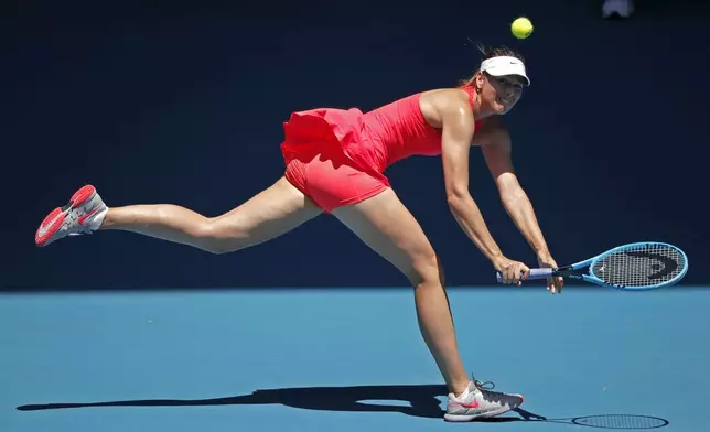 FILE - Russia's Maria Sharapova makes a backhand return to Croatia's Donna Vekic during their first round singles match at the Australian Open tennis championship in Melbourne, Australia, Jan. 21, 2020. (AP Photo/Lee Jin-man, File)