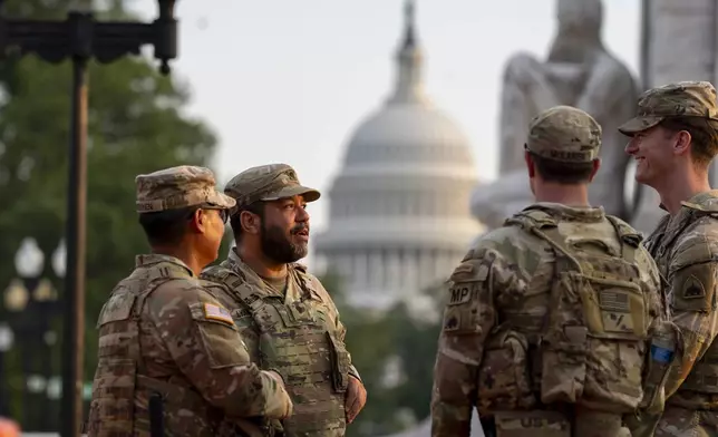 District of Columbia National Guard soldiers stand at Union Station with the U.S. Capitol behind them in Washington, Friday, Aug. 15, 2025, in Washington. (AP Photo/Alex Brandon)