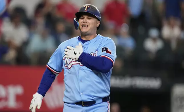 Texas Rangers' Joc Pederson celebrates his two-run home run in the first inning of a baseball game against the Philadelphia Phillies Sunday, Aug. 10, 2025, in Arlington, Texas. (AP Photo/Tony Gutierrez)