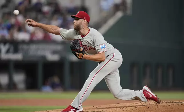 Philadelphia Phillies starting pitcher Zack Wheeler throws to the Texas Rangers in the first inning of a baseball game Sunday, Aug. 10, 2025, in Arlington, Texas. (AP Photo/Tony Gutierrez)