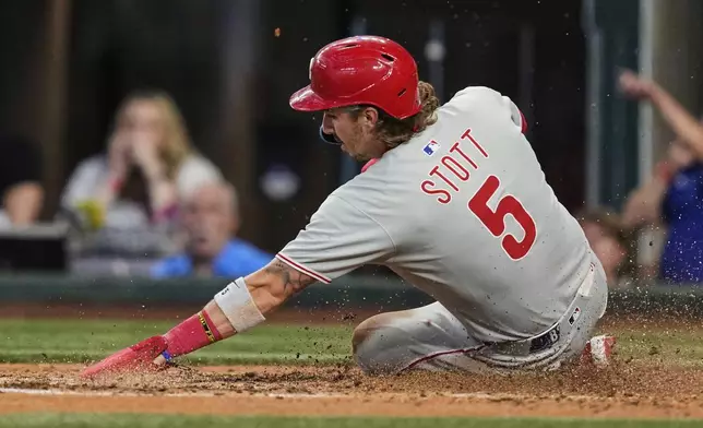 Philadelphia Phillies' Bryson Stott scores on a Weston Wilson single in the fifth inning of a baseball game against the Texas Rangers, Sunday, Aug. 10, 2025, in Arlington, Texas. (AP Photo/Tony Gutierrez)