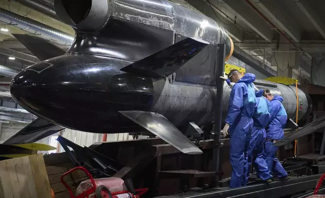 Workers inspect a Flamingo cruise missile at Fire Point's secret factory in Ukraine on Monday, Aug. 18, 2025. (AP Photo/Efrem Lukatsky)