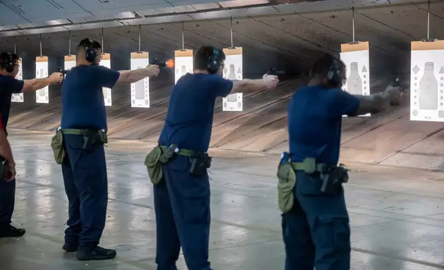 Immigration and Customs Enforcement (ICE) trainees practice shooting a handgun at the indoor firing range at the Federal Law Enforcement Training Centers (FLETC) in Brunswick, Ga. on Thursday, Aug. 21, 2025. (AP Photo/Fran Ruchalski)