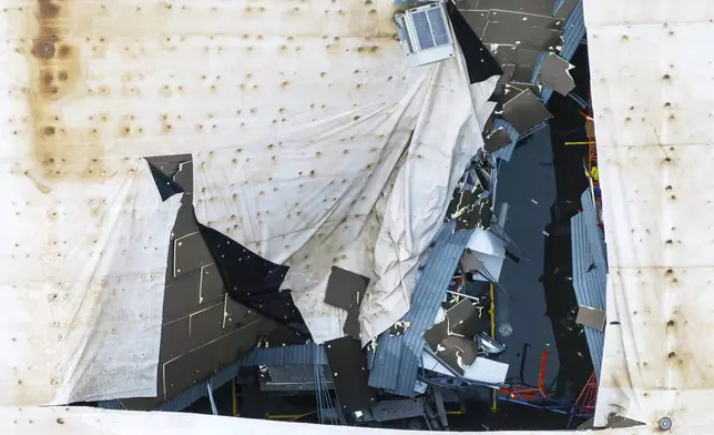 A hole is seen in the roof of the Dollar General distribution warehouse located at 1200 S 10th Streeet in Blair, Neb. on Saturday, Aug. 9, 2025, after an early morning storm caused widespread wind damage in the area. (Chris Machian/Omaha World-Herald via AP)