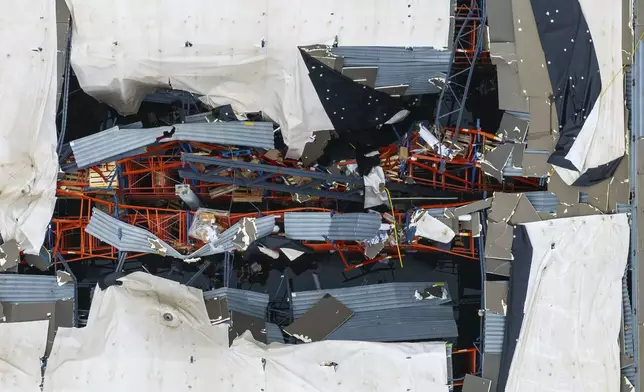 A hole is seen in the roof of the Dollar General distribution warehouse located at 1200 S 10th Streeet in Blair, Neb. on Saturday, Aug. 9, 2025, after an early morning storm caused widespread wind damage in the area. (Chris Machian/Omaha World-Herald via AP)
