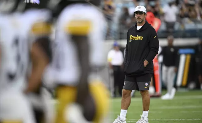 Pittsburgh Steelers' Aaron Rodgers watches before an NFL preseason football game against the Jacksonville Jaguars, Saturday, Aug. 9, 2025, in Jacksonville, Fla. (AP Photo/Phelan M. Ebenhack)