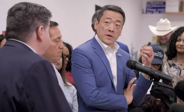 Texas House Democratic Caucus Chair Gene Wu along with other members of the Texas House are joined by Illinois Governor JB Pritzker as they speak about Texas Republican plans to redraw the House map office during a press conference at the Democratic Party of DuPage County office in Carol Stream, IL on Sunday, Aug. 3, 2025. (AP Photo/Mark Black)