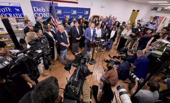Texas House Democratic Caucus Chair Gene Wu along with other members of the Texas House are joined by Illinois Governor JB Pritzker as they speak about Texas Republican plans to redraw the House map office during a press conference at the Democratic Party of DuPage County office in Carol Stream, IL on Sunday, Aug. 3, 2025. (AP Photo/Mark Black)