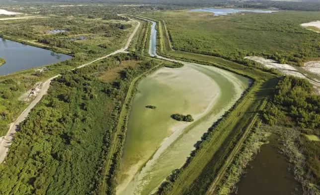 A liquid discharge spills into a waterway from Nutrien, a large phosphate mine in White Springs, Fla., Tuesday, July 15, 2025. (AP Photo/Daniel Kozin)