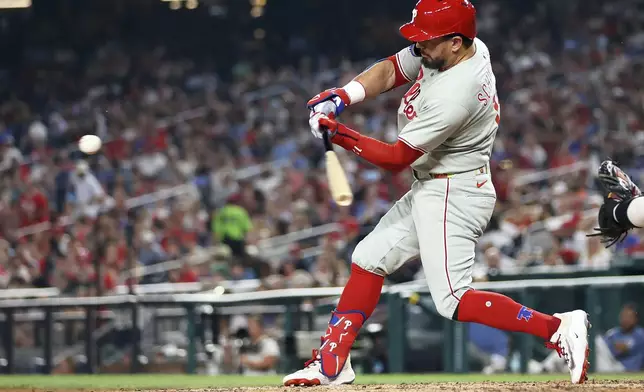 Philadelphia Phillies' Kyle Schwarber hits a home run during the seventh inning of a baseball game against the Washington Nationals, Friday, Aug. 15, 2025, in Washington. (AP Photo/Daniel Kucin Jr.)
