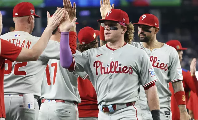 The Philadelphia Phillies celebrate after a baseball game against the Washington Nationals, Friday, Aug. 15, 2025, in Washington. (AP Photo/Daniel Kucin Jr.)