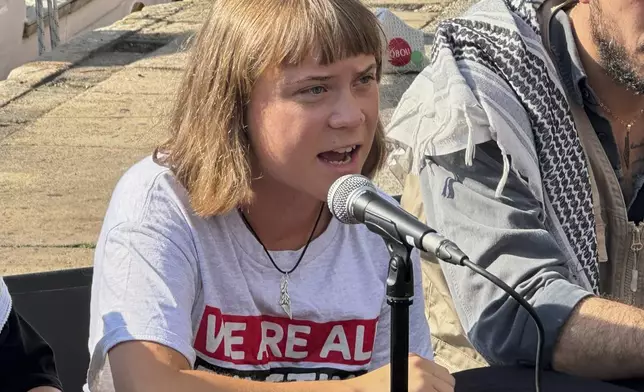 Swedish climate activist Greta Thunberg speaks during a news conference ahead of the launch of a civilian flotilla bound for Gaza, aiming to break the Israeli blockade and deliver humanitarian aid in Barcelona, Spain, Sunday, Aug. 31, 2025. (AP Photo/Hernan Munoz)