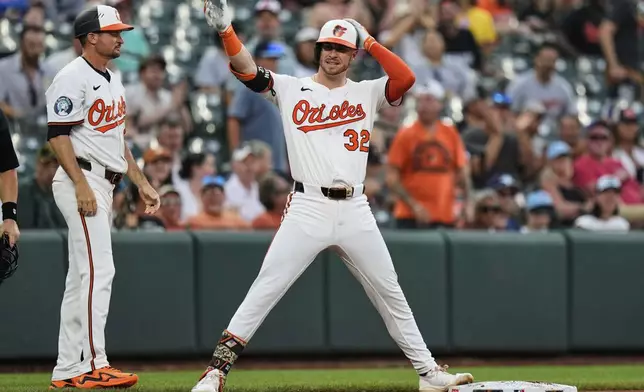 Baltimore Orioles' Ryan O'Hearn (32) celebrates after hitting an RBI triple during the fourth inning in the second baseball game of a doubleheader against the Toronto Blue Jays, Tuesday, July 29, 2025, in Baltimore. (AP Photo/Stephanie Scarbrough)