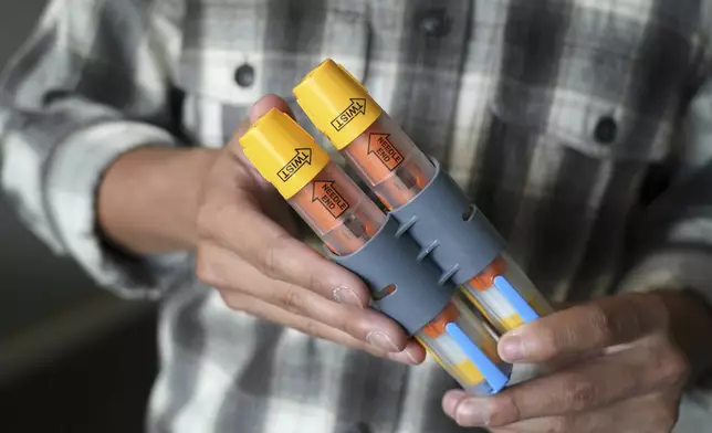 Braxton Kimura shows his EpiPens at home on Wednesday, Aug. 13, 2025, in San Jose, Calif. (AP Photo/Terry Chea)
