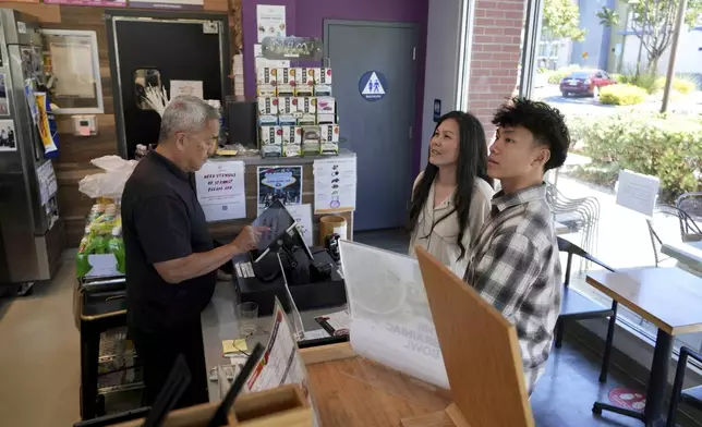 Braxton Kimura, right, orders food with his mother Carol Kimura at Vitality Bowl on Wednesday, Aug. 13, 2025, in San Jose, Calif. (AP Photo/Terry Chea)
