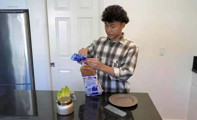 Braxton Kimura prepares food at home on Wednesday, Aug. 13, 2025, in San Jose, Calif. (AP Photo/Terry Chea)