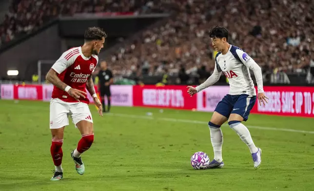 Tottenham Hotspur's Son Heung Min, right, takes on Arsenal's Ben White during a friendly soccer match between Arsenal FC and Tottenham Hotspur, Thursday, July 31, 2025, at the Hong Kong Football Festival at the Kai Tak Stadium in Hong Kong. (AP Photo/Chan Long Hei)