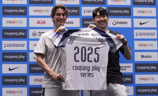 Tottenham Hotspur's coach Thomas Frank, left, and his player Son Heung-min pose for photos after a press conference ahead of a preseason soccer match between Tottenham Hotspur and Newcastle United in Seoul, South Korea, Saturday, Aug. 2, 2025. (AP Photo/Ahn Young-joon)