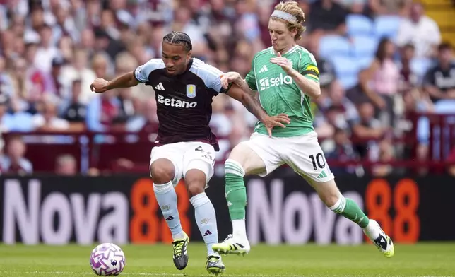 Aston Villa's Boubacar Kamara, left, and Newcastle United's Anthony Gordon, right, challenge for the ball during the English Premier League soccer match between Aston Villa and Newcastle United in Birmingham, England, Saturday, Aug. 16, 2025.David Davies/PA via AP)