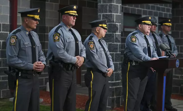 Pennsylvania State Police Commander Colonel Christopher L. Paris and District Attorney Marion O'Malley, third right, answer questions about the Pennsylvania state trooper ambush in Susquehanna County, Pa., at the barracks, Thursday, Aug. 7, 2025, in Gibson, Pa. (AP Photo/Aimee Dilger)