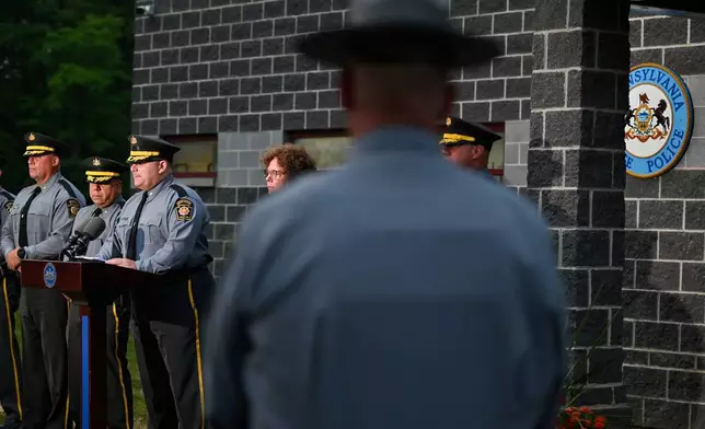 Pennsylvania State Police Commander Colonel Christopher L. Paris and District Attorney Marion O'Malley answer questions in the Pennsylvania state trooper ambush in Susquehanna County, at the barracks, Thursday, Aug. 7, 2025, in Gibson, Pa. (AP Photo/Aimee Dilger)