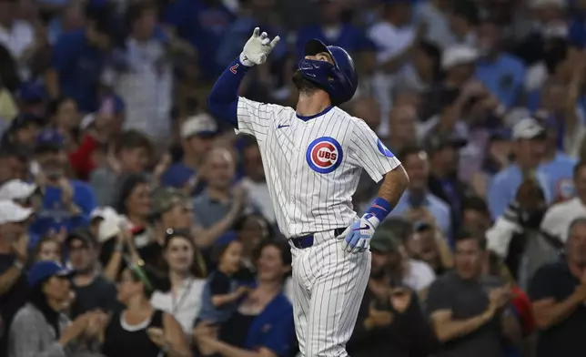 Chicago Cubs' Dansby Swanson celebrates after hitting a two-run home run during the third inning of a baseball game against the Cincinnati Reds, Monday, Aug. 4, 2025, in Chicago. (AP Photo/Paul Beaty)