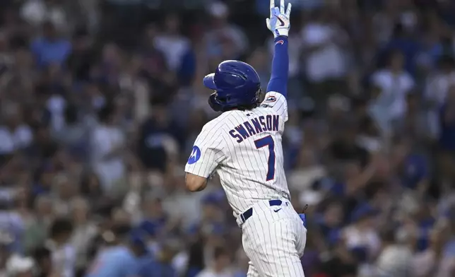 Chicago Cubs' Dansby Swanson celebrates while rounding the bases after hitting a two-run home run during the third inning of a baseball game against the Cincinnati Reds, Monday, Aug. 4, 2025, in Chicago. (AP Photo/Paul Beaty)
