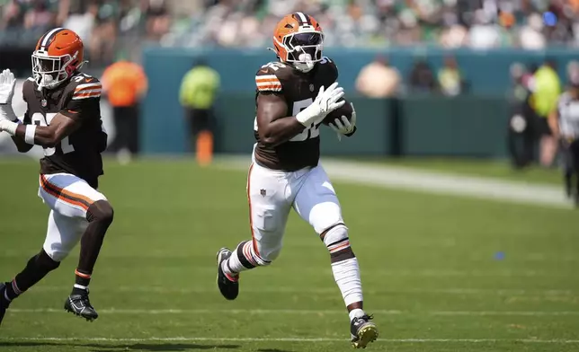 Cleveland Browns defensive end KJ Henry (52) runs for a touchdown after an interception during the second half of an NFL preseason football game against the Philadelphia Eagles on Saturday, Aug. 16, 2025, in Philadelphia.(AP Photo/Chris Szagola)