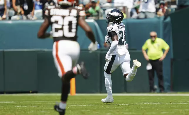 Philadelphia Eagles' Andrew Mukuba (24) looks back at Cleveland Browns running back Pierre Strong Jr. (20) as he runs for a touchdown after an interception during the first half of an NFL preseason football game Saturday, Aug. 16, 2025, in Philadelphia. (AP Photo/Derik Hamilton)