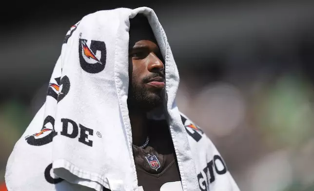 Cleveland Browns quarterback Shedeur Sanders covers his head during the first half of an NFL preseason football game against the Philadelphia Eagles on Saturday, Aug. 16, 2025, in Philadelphia. (AP Photo/Matt Rourke)