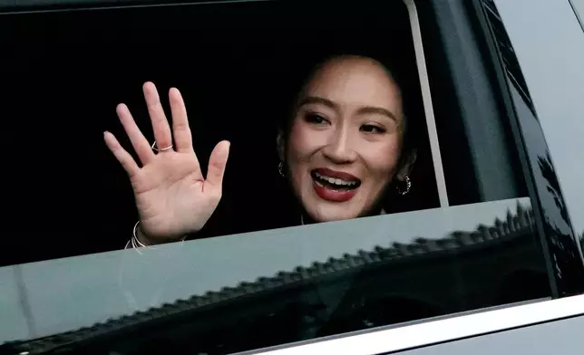 Thailand's suspended Prime Minister Paetongtarn Shinawatra waves as she leaves the Government House after being dismissed from her position, in Bangkok, Thailand, Friday, Aug. 29, 2025. (AP Photo/Sakchai Lalit)