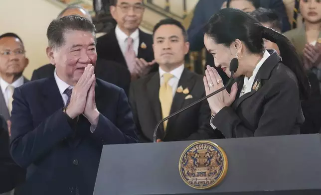 Thailand's suspended Prime Minister Paetongtarn Shinawatra, right, gestures at acting Prime Minister Phumtham Wechayachai during a press conference after her dismissal, in Bangkok, Thailand, Friday, Aug. 29, 2025. (AP Photo/Sakchai Lalit)