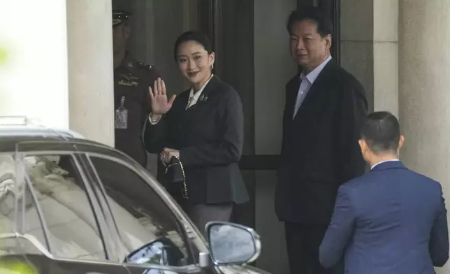 Thailand's suspended Prime Minister Paetongtarn Shinawatra, left, arrives at Government House in Bangkok, Thailand, Friday, Aug. 29, 2025. (AP Photo/Sakchai Lalit)
