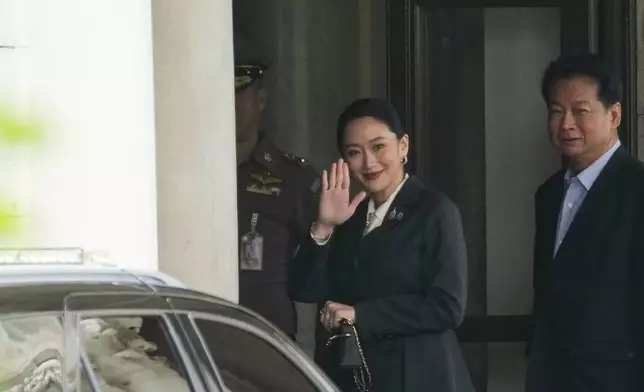 Thailand's suspended Prime Minister Paetongtarn Shinawatra, center, arrives at Government House in Bangkok, Thailand, Friday, Aug. 29, 2025. (AP Photo/Sakchai Lalit)