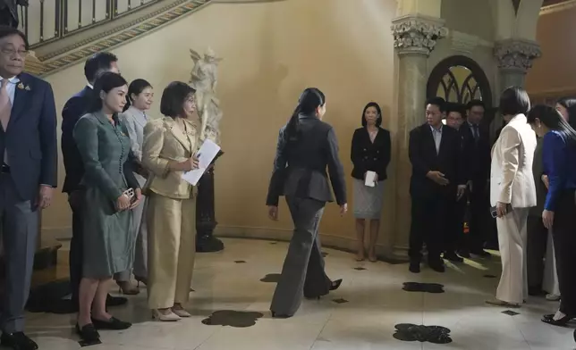 Thailand's suspended Prime Minister Paetongtarn Shinawatra, center, leaves a press conference after her dismissal, in Bangkok, Thailand, Friday, Aug. 29, 2025. (AP Photo/Sakchai Lalit)