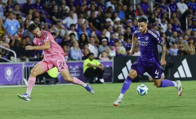 Orlando City defender David Brekalo (4) gets the ball away from Inter Miami forward Tadeo Allende (21) during the first half of an MLS soccer match, Sunday, Aug. 10, 2025, in Orlando, Fla. (AP Photo/Kevin Kolczynski)