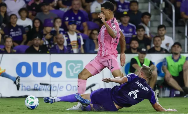 Orlando City defender Robin Jansson (6) kicks the ball away from Inter Miami defender Ian Fray (17) during the first half of an MLS soccer match, Sunday, Aug. 10, 2025, in Orlando, Fla. (AP Photo/Kevin Kolczynski)
