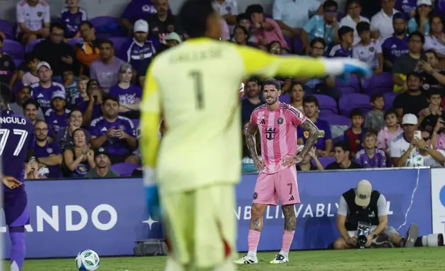Inter Miami midfielder Fafà Picault (7) gets ready for penalty kick against Orlando City goalkeeper Pedro Gallese (1) during the first half of an MLS soccer match, Sunday, Aug. 10, 2025, in Orlando, Fla. (AP Photo/Kevin Kolczynski)