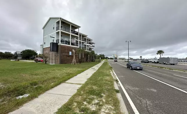 Elevated new houses stand west of downtown Aug. 12, 2025, in Gulfport, Miss. (AP Photo/Jeff Amy)