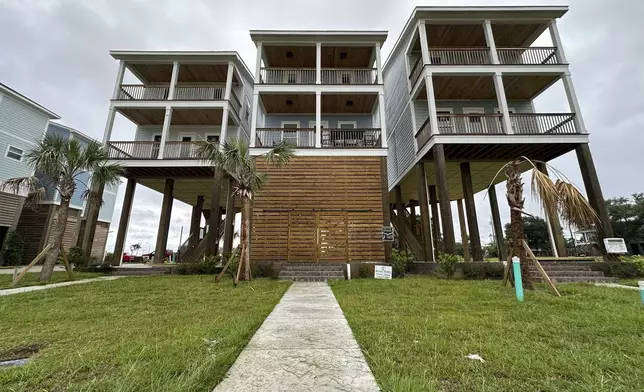 Elevated new homes stand west of downtown Aug. 12, 2025, in Gulfport, Miss. (AP Photo/Jeff Amy)